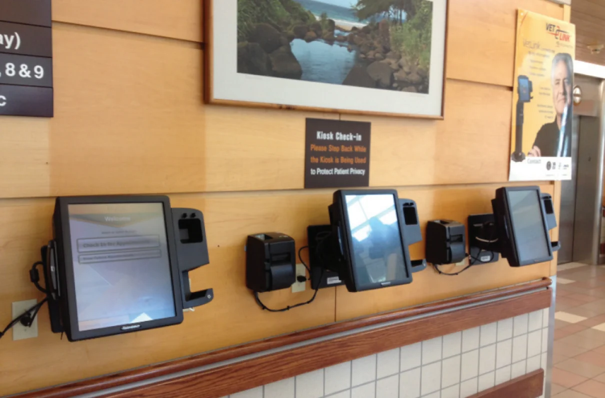 Multiple Vecna VetLink kiosks installed in a hospital corridor.